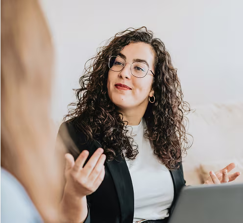 A woman explaining something during a conversation indoors